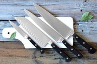We love Cooking – Set of kitchen knives on a board, top view