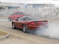 Street Outlaws – Tina Pierce's red sportscar along with Justin's truck.