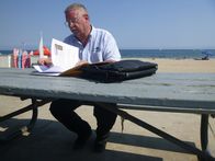 When Sharks Attack - Hai-Alarm – SANTA BARBARA, CALIF. - Ralph Collier looking at case files on the beach. (National Geographic/Tristan Walker)