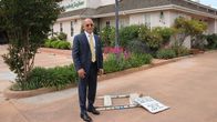 Hotel Impossible – Host Anthony Melchiorri stands next to a broken sign outside the Posada de San Juan in San Juan Bautista, California.