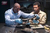 Mayday - Alarm im Cockpit – The Lead Namibian Investigator (played by Jamaal Grant) and Investigator Dennis Jones (played by Glen Michael Grant) work together to analyze pieces of wreckage to find out what downed LAM Mozambique Flight 470. (Cineflix/Pana Pantazidis)