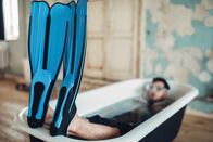 111 – Funny businessman in flippers and mask lies in bathtub, humor. Business lottery concept
