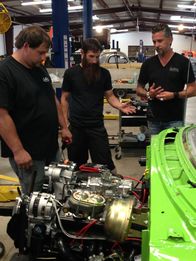 Fast N' Loud – L-R: Jordan Butler, Aaron Kaufman and Richard Rawlings survey the 56 Chevy Nomad engine.