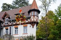 Wohnen mal anders – half-timbered house fragment, Picturesque German village in autumn, old Hesse and trees, picturesque European neighborhood surrounded by dense, colorful woodland during beautiful autumn season