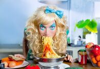 111 – Blonde funny girl on kitchen eating pasta like crazy with blue makeup