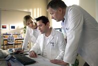 In aller Freundschaft – Dr. Philipp Brentano (Thomas Koch, Mitte) hält das Leberkarzinom seines Patienten für inoperabel. Dr. Roland Heilmann (Thomas Rühmann, rechts) schätzt das genauso ein. Das Risiko einer OP ist unkalkulierbar. Die beiden plädieren dafür, den Patienten auf die Liste für eine Spenderleber zu setzen. Als sich Dr. Lea Peters (Anja Nejarri) einmischt, fragt Philipp sie, ob sie keine eigenen Patienten habe, um die sie sich kümmern könne.