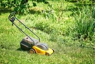 111 – lawn mower on lawn with cut grass part.