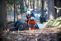 Mayday - Alarm im Cockpit – Investigator Bob Benzon (played by Kevin Carter) and recovery workers (played by background actors) sort through the debris of Alitalia flight 404.