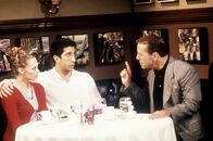 Friends – Ross (Davis Schwimmer, M.) hat das große Vergnügen, den Vater von Elizabeth (Alexandra Holden, l.), Mr. Stevens (Bruce Willis, r.), bei einem Dinner kennen zu lernen.