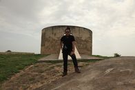 I Wouldn't Go In There – Diu, India: RJ striking a pose infront of the Tower of Silence. The Tower of Silence also called Dakma, is a circular structure used by Zoroastrians to leave their dead exposed for scavenging birds to devour. Zoroastrianism was founded by Persians about 3500 years ago. Facing oppression from Arab rulers, Persians fled to India between the 10th to 20th century, bringing with them their beliefs and practices. (Photo Credit: National Geographic Channels/Singha Quansuwan)