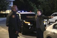 The Big Bang Theory – Während Leonard und Penny mit ihren Freunden und der Familie essen gehen, werden Howard (Simon Helberg, r.), Raj und Bernadette auf dem Weg dorthin von einem Police Officer (Marcus Folmar, l.) angehalten. Ist etwa ihre neue Erfindung der Grund dafür?