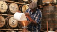 Moonshiners: Master Distiller – Leo pouring mash into still