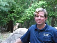 Geheimakte Wildnis – Guy Lichty, a mammal curator at the North Carolina Zoo with a Red Wolf in the background.