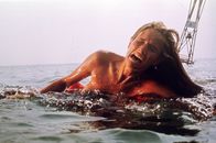 Der weiße Hai – Eine Frau (unbekannt) wird beim Schwimmen im Meer vor Amity von einem Hai angegriffen und tödlich verletzt.