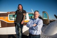 Airplane Repo - Die Inkasso-Piloten – L-R: Danny Thompson and Ken Cage outside an airplane.