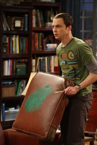 The Big Bang Theory – Penny schießt versehentlich mit dem Paintballgewehr und trifft ausgerechnet das Kissen auf Sheldons (Jim Parsons) geheiligtem Platz auf der Couch. Ein fataler Schuss ...