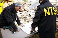 Mayday - Alarm im Cockpit – REENACTMENT: Clint Crookshanks (played by Jason Weinberg) and a firefighter navagate through the smouldering wreckage of a Bombardier commercial jet to locate and retrieve the black boxes from the flight, which mysteriously fell from the sky miinutes from landing at Buffalo's airport.