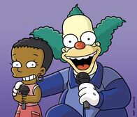Die Simpsons – Beim Gesangswettbewerb: Lisa (l.) und Krusty (r.) ...