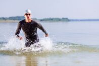 Triathlon: World Cup – Triathlon swimmer splashing around while running out of water