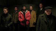 Captive State – (L - R) Caitlin Ewald as Anita, James Ransone as Ellison, Jonathan Majors as Rafe, Ben Daniels as Daniel, Lawrence Grimm as Hayes, and Gus Van Swearingen as Eddie the Priest in Rupert Wyatt's CAPTIVE STATE, a Focus Features release. Credit: Parrish Lewis / Focus Features; CS_Day16_0397.arw; (L - R) Caitlin Ewald as Anita, James Ransone as Ellison, Jonathan Majors as Rafe, Ben Daniels as Daniel, Lawrence Grimm as Hayes, and Gus Van Swearingen as Eddie the Priest in Rupert Wyatt's CAPTIVE STATE.