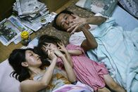 Shoplifters – L-R: Nobuyo Shibata (Sakura Andô), Yuri Hojo (Miyu Sasaki), Osamu Shibata (Lily Franky)