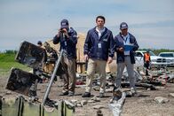 Mayday - Alarm im Cockpit – JIAAC Investigator Augusto De Santis (played by John Philip Vazquez) and the rest of the investigators stand at the crash site of SOL Lineas Aerias Flight 5428. (Cineflix 2019/Darren Goldstein)