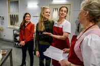 Sturm der Liebe – Clara (Jeannine Wacker, l.) platzt mit Ella (Victoria Reich, 2.v.l.) in die Küche und überascht Tina (Christin Balogh, 3.v.l.), die sich gerade mit Hildegard (Antje Hagen, r.) unterhält.