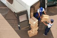 ATV - Die Reportage – Male movers unloading boxes from van outdoors, above view