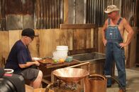 Moonshiners: Master Distiller – Tim looking over Jason's still.