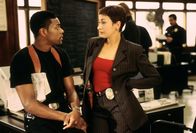 Rush Hour – Detective James Carter (Chris Tucker), Tania Johnson (Elizabeth Pena)