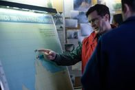 Mayday - Alarm im Cockpit – A Nepalese investigator (played by Leon Aureus) and Andrew Robinson (played by Philip Graeme) map out the trajectory of Pakistan International Airlines Flight 268's stepped descent over the Himalayan mountains that led to the tragic accident. (Cineflix 2019/Darren Goldstein)