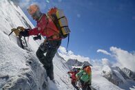 Explorer - Das Magazin – KACHIN, MYANMAR- The team climbs towards a shoulder on the unclimbed west ridge of Hkakabo Razi. Shot on assignment for National Geographic Magazine in Myanmar for assignment MM8252 Covering the sea to summit exploration for South East Asia's highest point. Team members include Mark Jenkins (light green and grey), Hilaree O'Neil (grn), Renan Ozturk (red), Emily Harrington (pink), Taylor Reese (not present).