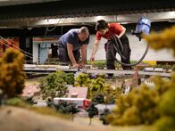 Die Modellbauer - Das Miniatur Wunderland – Wolfgang and Lars repair the tracks on a bridge in the Northeast Sea, which is filled with 30,000 liters of water.