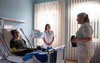In aller Freundschaft – Schwester Miriam (Christina Petersen, re.) ist so aufgeregt, dass Luzie Herbst (Anne-Marie Lux, li.), die Sängerin ihrer Lieblingsband, in der Sachsenklinik ist, dass sie die ganze Zeit quasselt. Oberschwester Arzu (Arzu Bazman, mi.) und Luzie selbst haben das Gefühl, dass sie es mit einem Groupie zu tun haben ... was ja auch ein bisschen so ist.