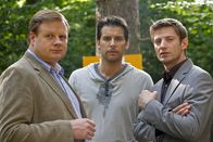 Die Rosenheim-Cops – Der Fall bekommt eine unerwartete Wendung, als Hartl (Michael A. Grimm, l.) und Hansen (Igor Jeftić, r.) ein pikantes Detail aus dem Leben von Kletterkursteilnehmer Lindmayr (Florian Odendahl, M.) erfahren.