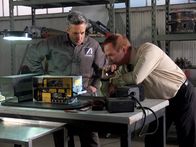 Mayday - Alarm im Cockpit – At AAIB Headquarters, Bob Benzon (played by Kevin Carter) and a mechanic (played by background actor) examine the Radio 1 Receiver to determine the cause of the Alitalia, flight 404, plane crash.