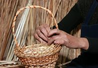 Im steirischen Vulkanland – Female hands manually mastering woven wicker basket