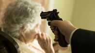 Your Worst Nightmare – A man pointing a gun at an elderly woman.