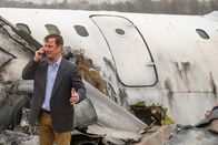 Mayday - Alarm im Cockpit – REENACTMENT - Surviving passenger of Ansett New Zealand Flight 703 William McGrory (played by Benjamin James) uses his phone to contact authorities. (Cineflix 2020/Darren Goldstein)