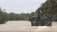 Chain of Command – Turbo, Colombia - A navel boat travels along a river in Turbo, Colombia. (National Geographic)