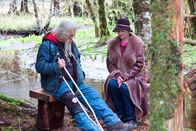 Alaskan Bush People – Billy Brown and Ami Brown sitting in the forest.
