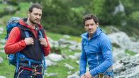 Die Bergretter – Die Bergführer Jan (Patrick G. Boll, l.) und Tobias (Markus Brandl, r.) beobachten den Streit zwischen den Eheleuten Lechner.