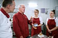 Sturm der Liebe – Josie (Lena Conzendorf, 2.v.r.) hofft, mit ihren Macarons bei André (Joachim Lätsch, 2.v.l.) punkten zu können (mit Komparsen).