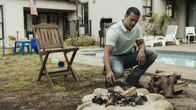American Monster – Nathan Residence - Garden: Eric (BLAZE AGULHAS) throws another log on the fire and gives Nathan (CHASE AGULHAS) a beer.