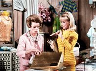 Bezaubernde Jeannie – Jeannie (Barbara Eden, r.) erzählt beim Kauf eines Kleides für Rogers 'Mod Party' der Verkäuferin von dem bevorstehenden Ereignis.