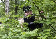 Hubert und Staller – Riedl (Paul Sedlmeir) versteckt sich in einer Hecke, da er befürchtet unter Beschuss zu geraten, weil er Hubert und Staller eine kugelsichere Weste bringen sollte.