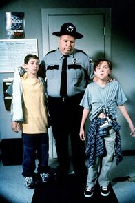 Malcolm mittendrin – Reese (Justin Berfield, l.) und Malcolm (Frankie Muniz, r.) werden von Officer Karl (Joel McKinnon Miller) bei einem Streit ertappt.