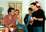 Kommissar Rex – Kommissar Brandtner (Gedeon Burkhard, r.) und Christian Böck (Heinz Weixelbraun, 2.v.r.) unterhalten sich mit dem Medizinstudenten Peter (George Lenz, l.) und seiner Mitbewohnerin Andrea (Loretta Pflaum, 2.v.l.) über Sybilles Gewohnheiten.
