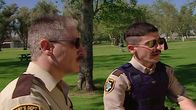 Reno 911! – L-R: Deputy James Garcia (Carlos Alazraqui), Deputy Travis Junior (Robert Ben Garant)
