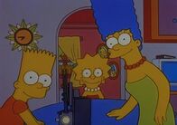 Die Simpsons – Bart, Lisa (Mi.) und Marge sehen sich alte Familienfilme an.